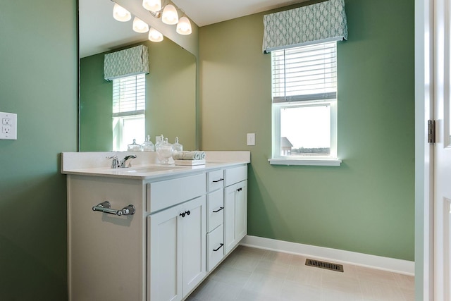 17232 Durham Dr, Lakeville, MN 55044 - bathroom with visible vents, a sink, baseboards, and a healthy amount of sunlight