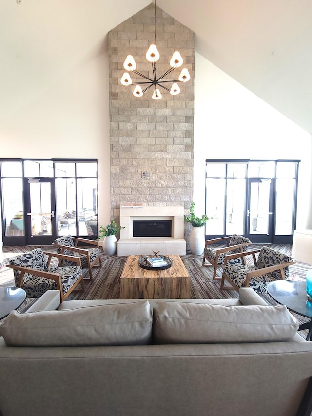17232 Durham Dr, Lakeville, MN 55044 - living room featuring an inviting chandelier, high vaulted ceiling, plenty of natural light, and a fireplace