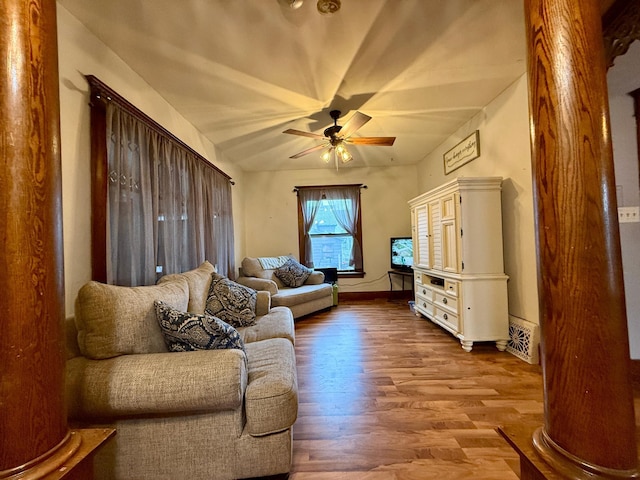 living room with baseboards, a ceiling fan, and wood finished floors