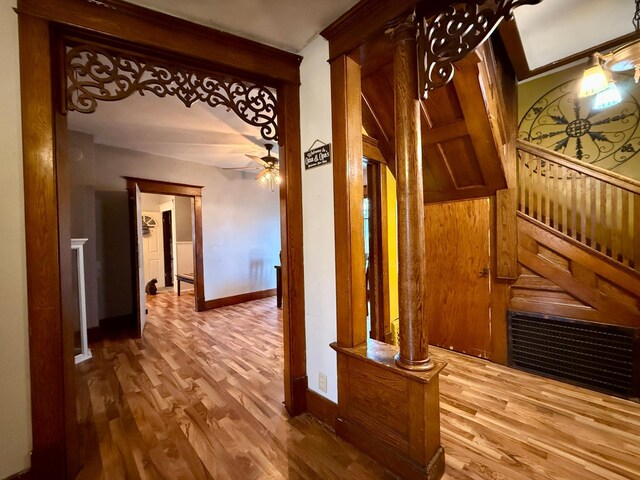 hallway with baseboards and wood finished floors