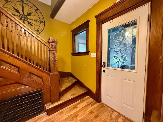 foyer entrance featuring stairs and light wood-type flooring