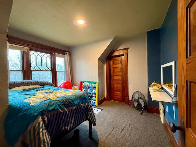 bedroom with baseboards, multiple windows, and carpet flooring