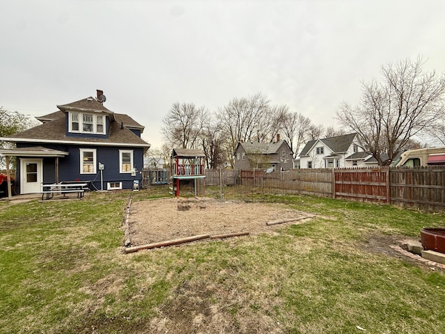 view of yard featuring a playground and fence