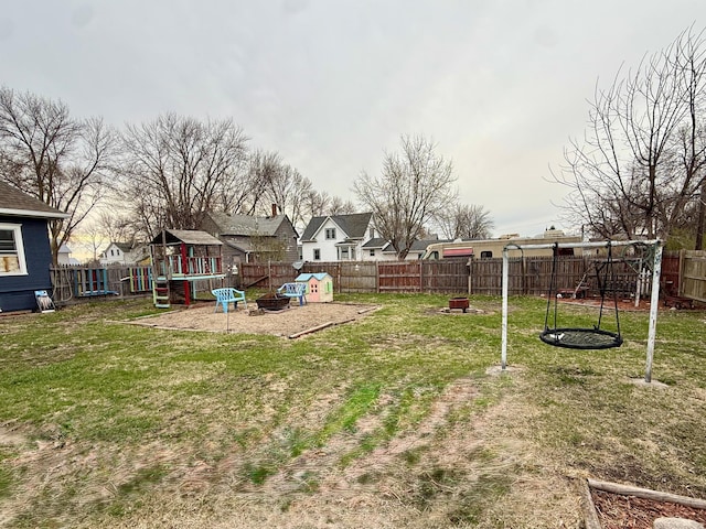 view of yard featuring a playground and a fenced backyard