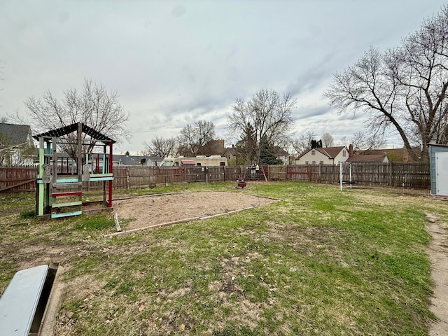 view of yard featuring a fenced backyard and a playground