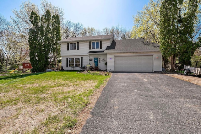 view of front of home with an attached garage, a front yard, and aphalt driveway