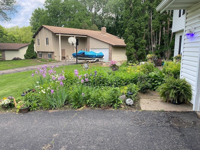 view of front facade with a garage and a front lawn