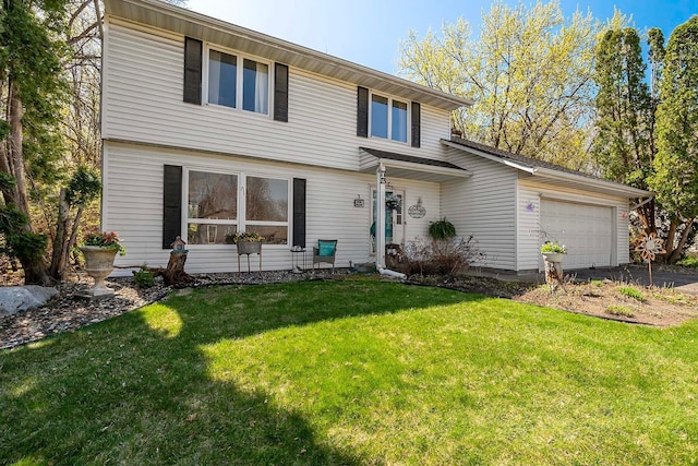 view of front of house with driveway, a front yard, and a garage