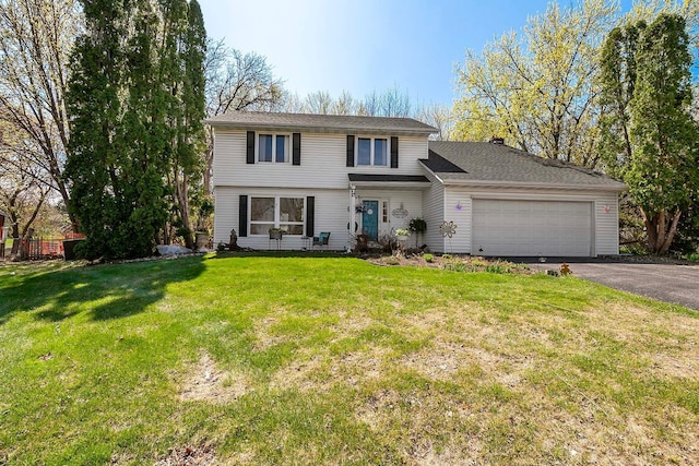view of front of property with a garage, a front lawn, and aphalt driveway