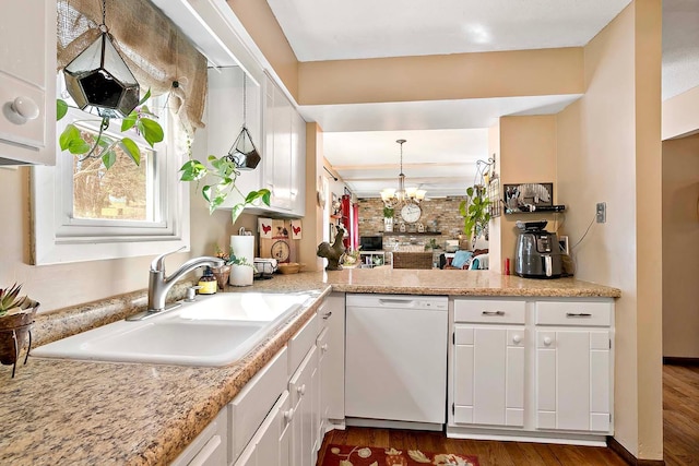 kitchen featuring white dishwasher, dark wood-style floors, light countertops, white cabinetry, and a sink