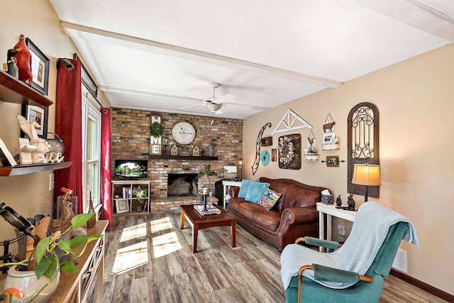 living room featuring visible vents, a brick fireplace, wood finished floors, baseboards, and a ceiling fan