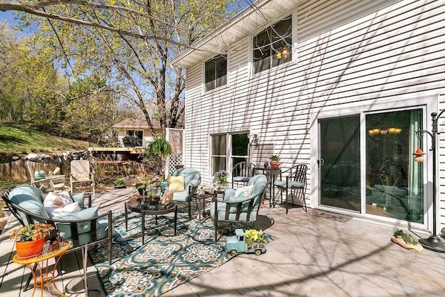 wooden deck with fence and outdoor lounge area
