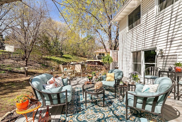 wooden deck with fence and outdoor lounge area