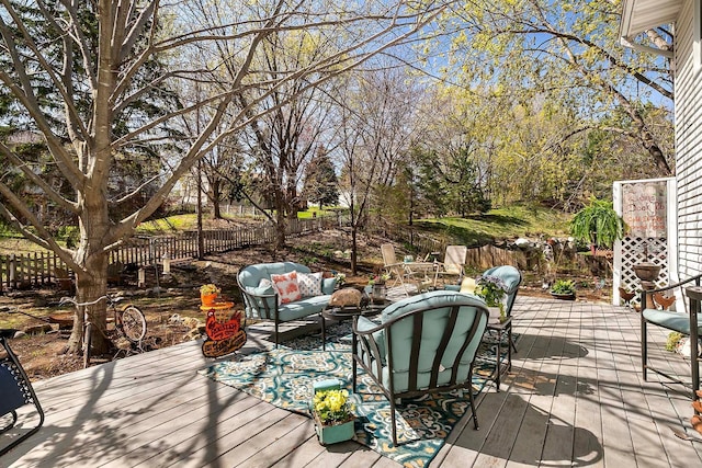 wooden deck featuring a fenced backyard and outdoor lounge area