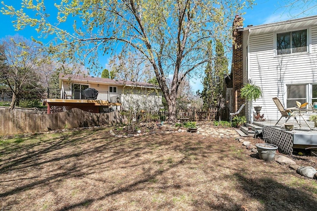 view of yard with a fenced backyard and a wooden deck
