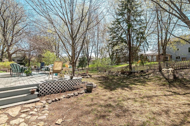 view of yard with a wooden deck and fence
