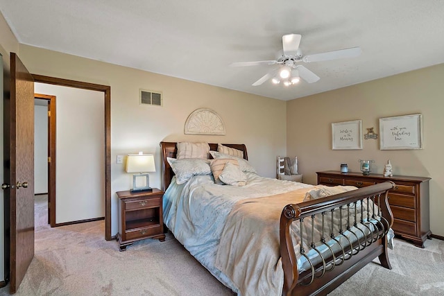 bedroom featuring baseboards, visible vents, a ceiling fan, and light colored carpet