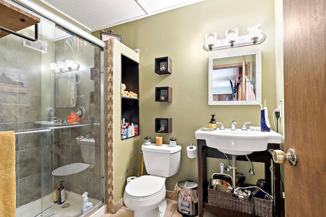 1713 James Pl, Burnsville, MN 55337 - bathroom featuring toilet, a stall shower, tile patterned flooring, and a sink