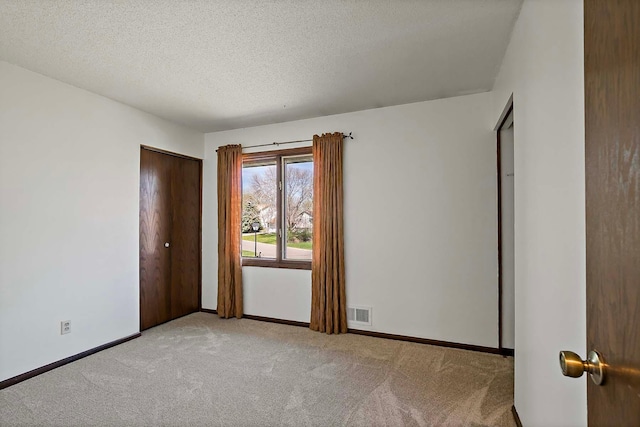 1713 James Pl, Burnsville, MN 55337 - spare room featuring carpet, a textured ceiling, and baseboards