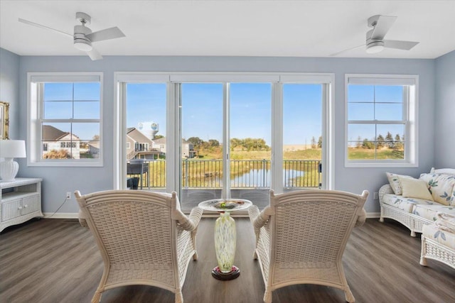 sunroom / solarium with a water view