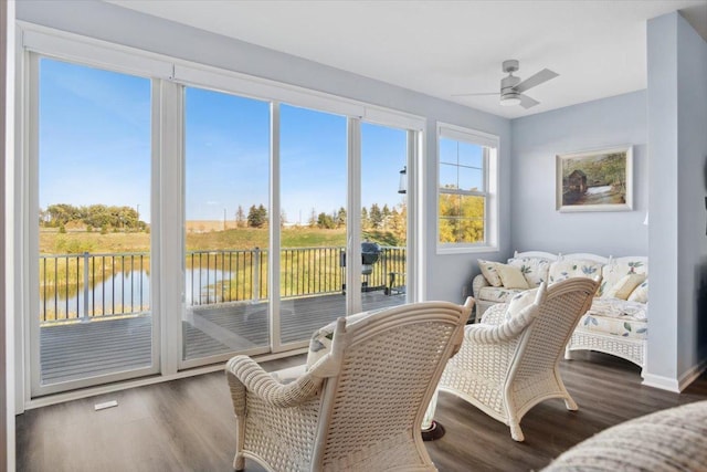 sunroom / solarium with a water view