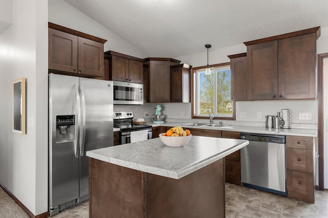 kitchen with lofted ceiling, stainless steel appliances, dark brown cabinets, a sink, and light countertops