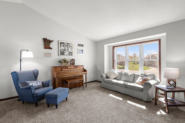 living area featuring carpet, baseboards, and lofted ceiling