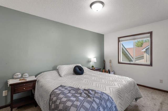 carpeted bedroom featuring a textured ceiling and baseboards