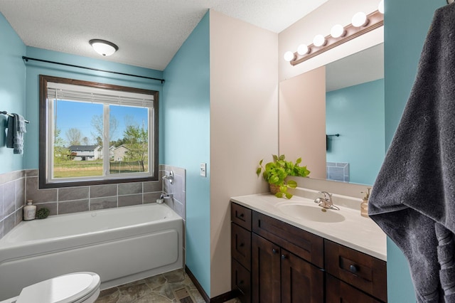 bathroom featuring a textured ceiling, toilet, visible vents, a garden tub, and vanity