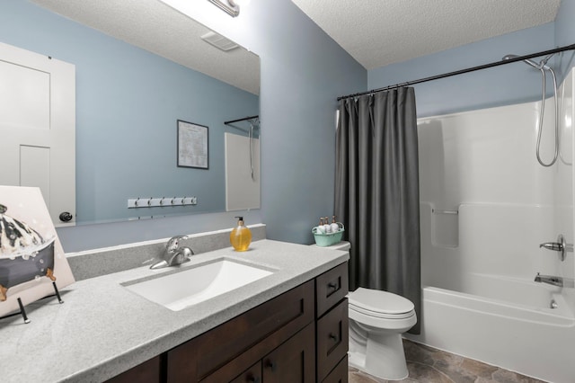 full bathroom with toilet, stone finish flooring, shower / tub combo with curtain, a textured ceiling, and vanity