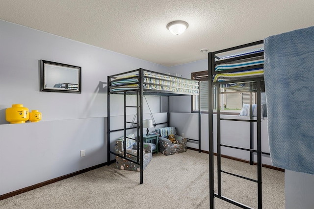 carpeted bedroom featuring a textured ceiling and baseboards