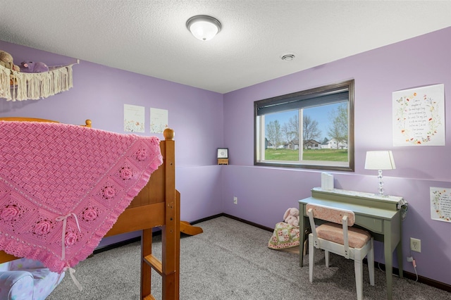 carpeted bedroom with a textured ceiling and baseboards