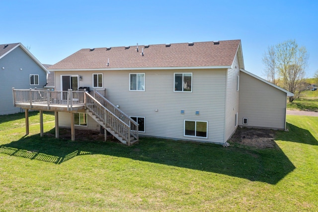 rear view of house featuring a shingled roof, a yard, stairway, and a wooden deck
