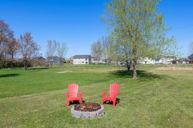 view of yard featuring a residential view and a fire pit