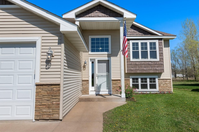 view of front of property featuring a garage, stone siding, and a front yard