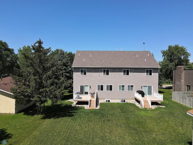 back of property featuring stairs, a lawn, and a deck