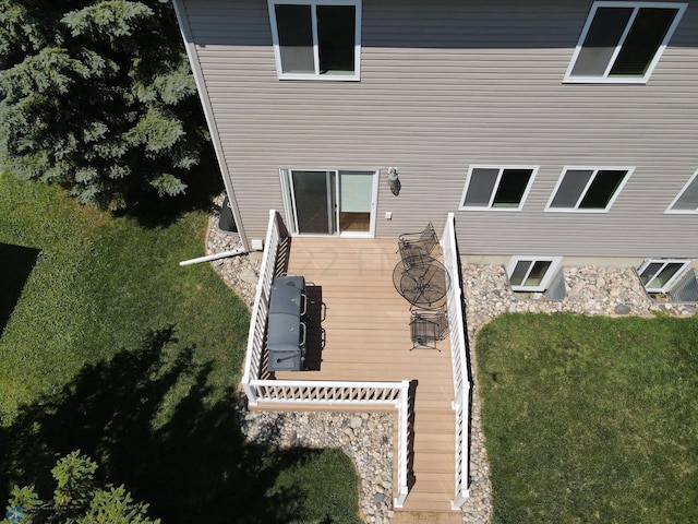 rear view of house featuring a lawn and a wooden deck