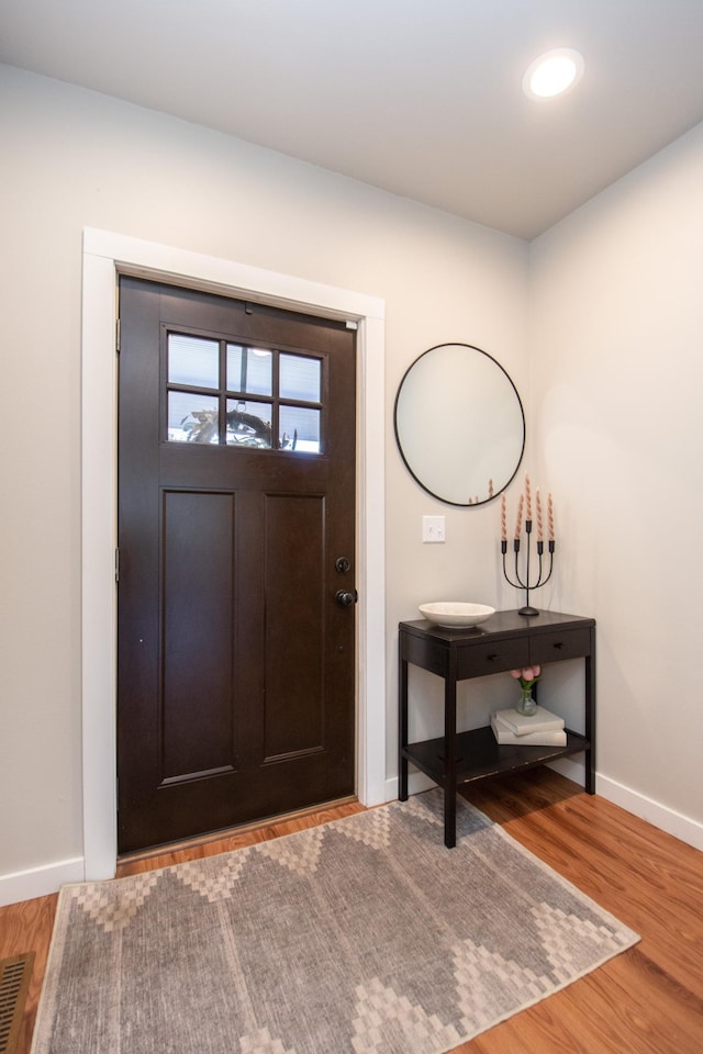 foyer entrance featuring baseboards, recessed lighting, wood finished floors, and visible vents