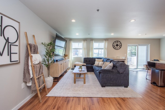 living room featuring recessed lighting, baseboards, and wood finished floors