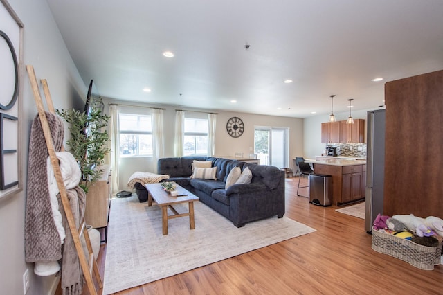 living area with recessed lighting and light wood-type flooring