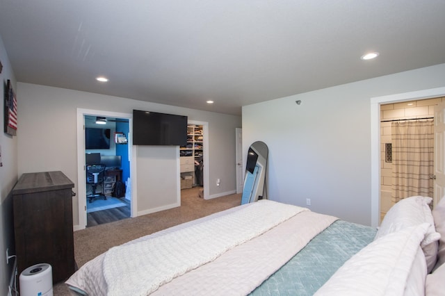 bedroom featuring light colored carpet, a spacious closet, recessed lighting, and a closet