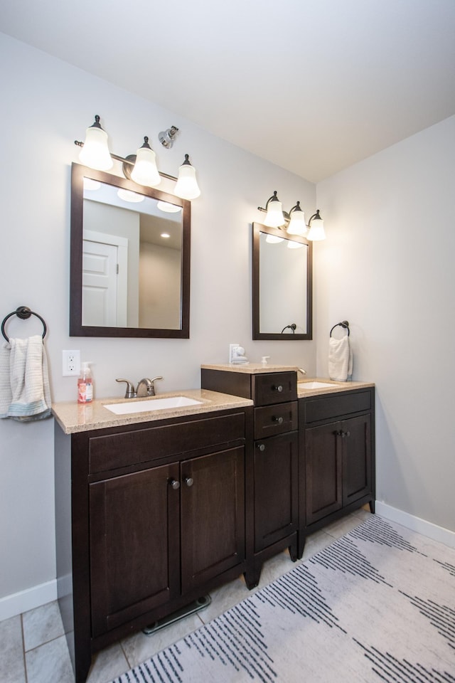 bathroom featuring baseboards, tile patterned flooring, and vanity