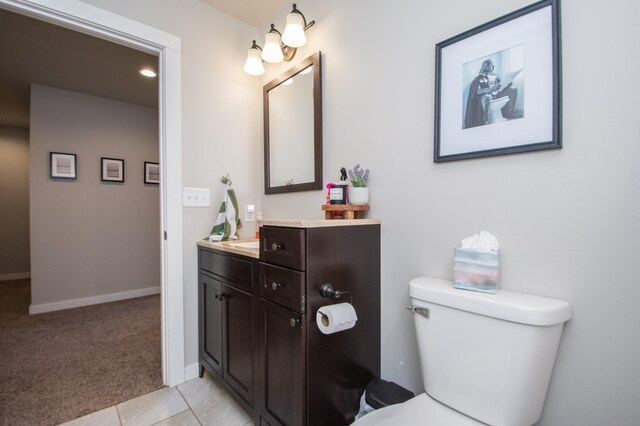 bathroom with vanity, baseboards, and toilet