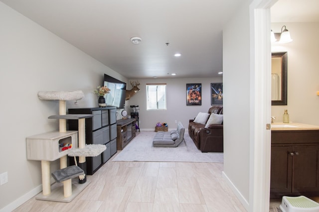 living area with baseboards and recessed lighting