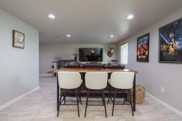 bar with recessed lighting, a dry bar, and baseboards