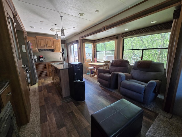 living room with dark wood-type flooring and recessed lighting