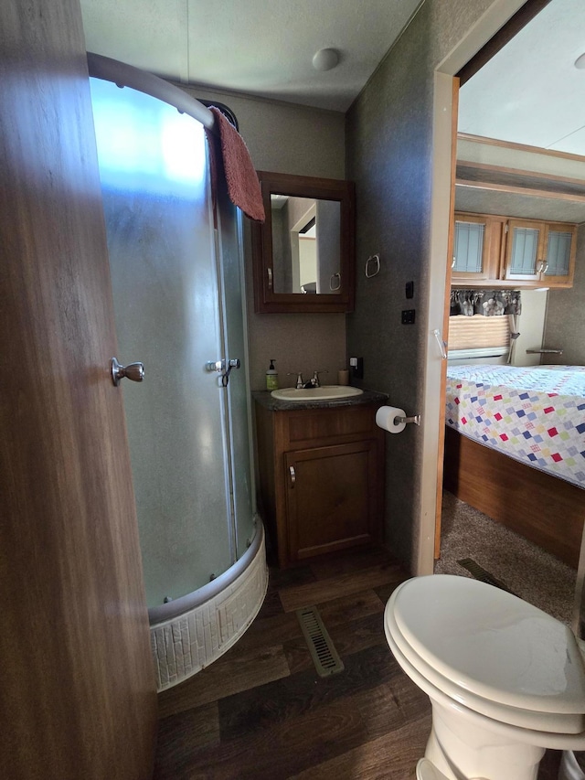 bathroom featuring vanity, visible vents, and wood finished floors