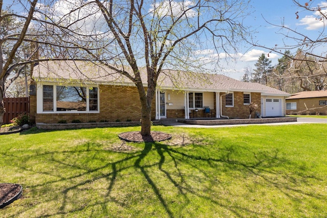 ranch-style house with fence, an attached garage, aphalt driveway, brick siding, and covered porch