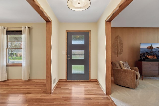 entrance foyer featuring visible vents, light wood-style flooring, and a healthy amount of sunlight