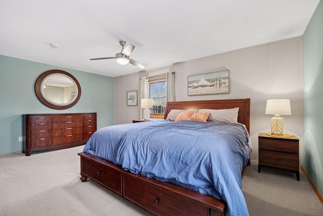 carpeted bedroom with ceiling fan and baseboards
